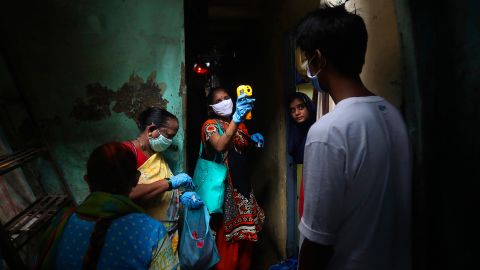 A health worker screens people for Covid-19 symptoms at Dharavi, one of Asia's biggest slums, in Mumbai, India. (AP Photo/Rafiq Maqbool)
