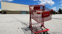 A broken JCPenney shopping cart is seen in an empty parking lot in Niles, Ill., Thursday, June 25, 2020. JCPenney is closing another 13 stores. The department store chain, which filed for bankruptcy last month, is inching toward its target of closing 250 stores about 30% of its network of 846 locations. (AP Photo/Nam Y. Huh)