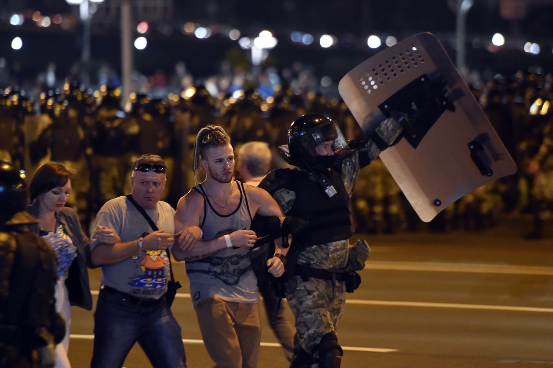 Riot police detain a group of demonstrators during a protest after polls closed in Belarus' presidential election, in Minsk on August 9, 2020.