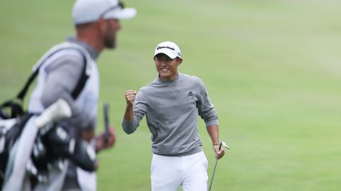 Morikawa celebrates chipping in for birdie on the 14th hole.