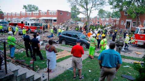 People gather outside an explosion site in Baltimore on Monday.
