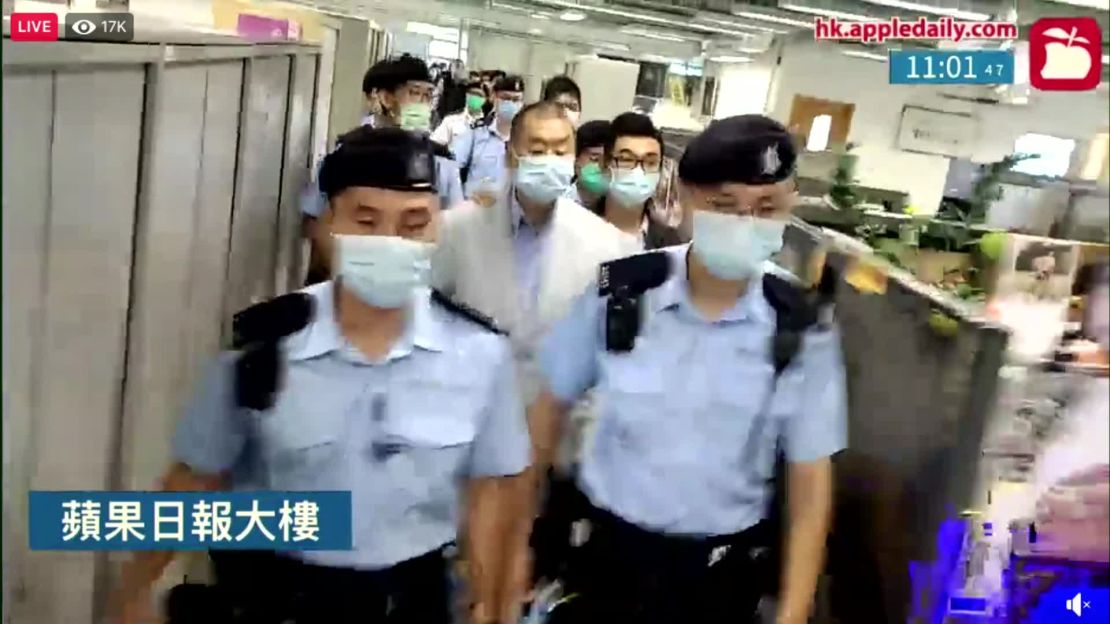 Jimmy Lai is escorted through the Apple Daily newsroom after being arrested under Hong Kong's national security law in August 2020.