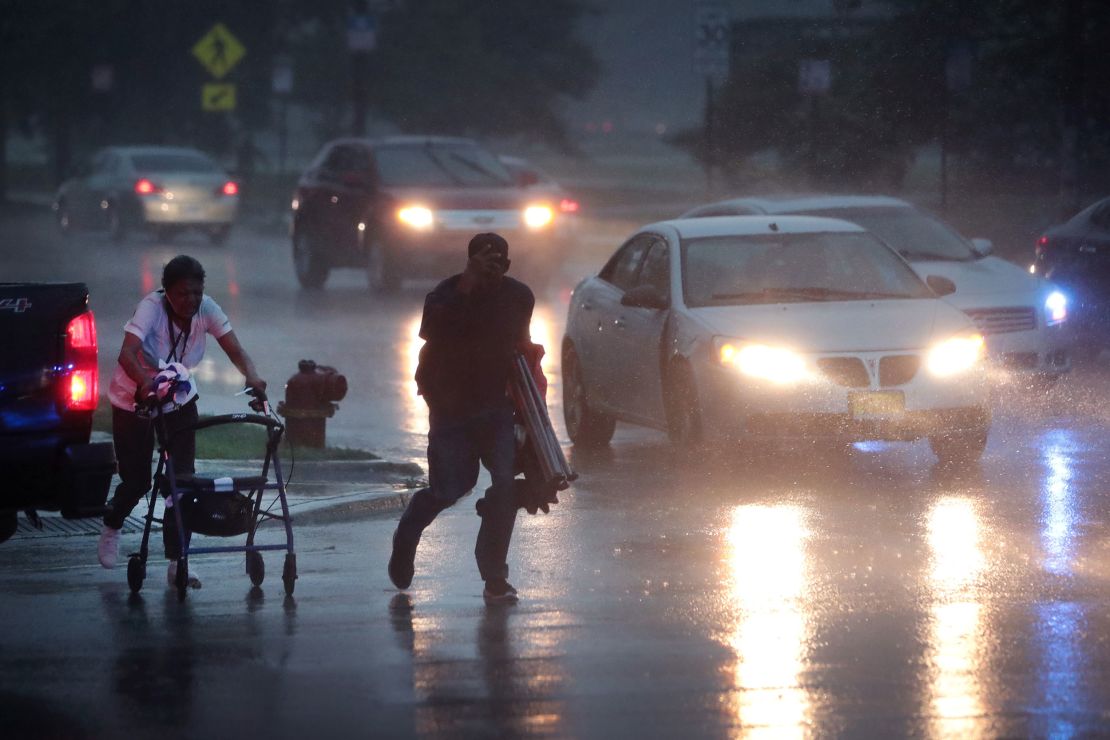 People search for cover as a derecho storm pushes through the Chicago area.