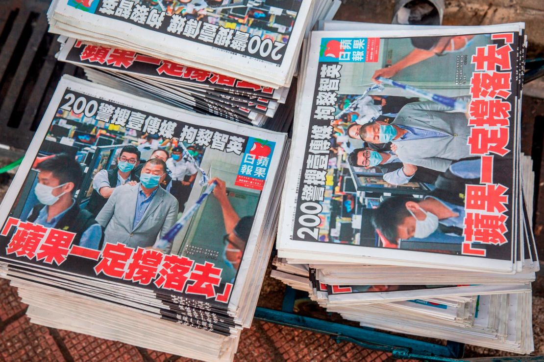 Copies of the Apple Daily newspaper -- paid for by a collection of pro-democracy district councillors -- sit on a cart before being handed out in Hong Kong on August 11, 2020, a day after authorities conducted a search of the newspaper's headquarters.