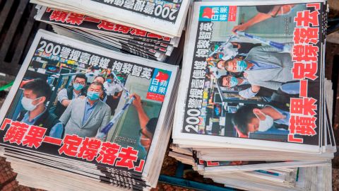 Copies of the Apple Daily newspaper -- paid for by a collection of pro-democracy district councillors -- sit on a cart before being handed out in Hong Kong on August 11, 2020, a day after authorities conducted a search of the newspaper's headquarters.