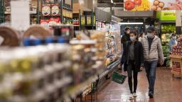 Costumers wearing masks walk inside a supermarket amid the COVID-19 pandemic on April 29, 2020 in New York City, United States. COVID-19 has spread to most countries around the world, claiming over 219,000 lives with over 3.1 million cases.  (Photo by Alexi Rosenfeld/Getty Images)