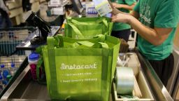 InstaCart employees fulfill orders for delivery at the new Whole Foods Market Inc. store in downtown Los Angeles, California, U.S., on Monday, Nov. 9, 2015. Located beneath the recently opened Eighth & Grand residences, the 41,000-square-foot store features a juice bar, fresh poke, expanded vegan options in all departments, a coffee bar (with cold brew on tap), more than 1,000 hand-picked wines, home delivery via Instacart and bar-restaurant The Eight Bar. Photographer: Patrick T. Fallon/Bloomberg via Getty Images