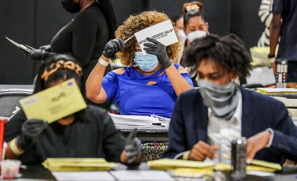 Election officials sort absentee ballots in Atlanta, w