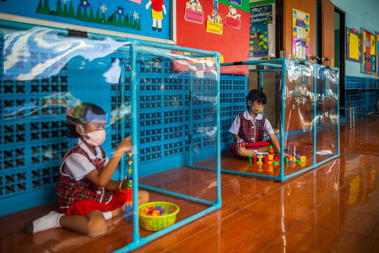 Kindergarten students wear face masks and play in screened-in areas at the Wat Khlong Toey School in Bangkok, Thailand, on Monday, August 10.