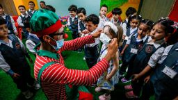 A clown hired by a local kindergarten instructs children how to wear a face mask during an awareness session about COVID-19 coronavirus disease at the premises in Gaza City (Photo by MOHAMMED ABED/AFP via Getty Images)
