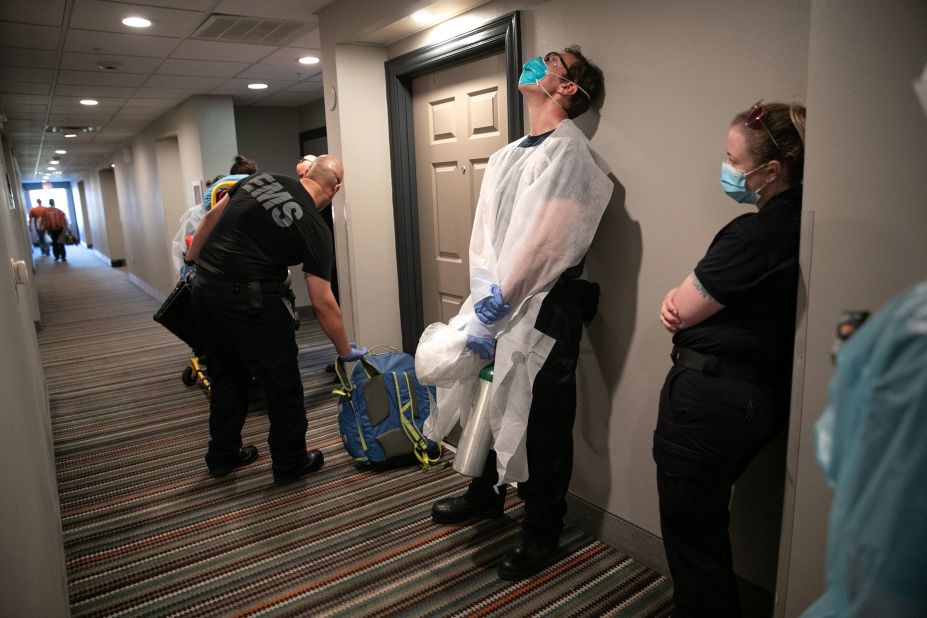 Medics wait to transport a woman with possible Covid-19 symptoms to a hospital in Austin, Texas, on August 7.