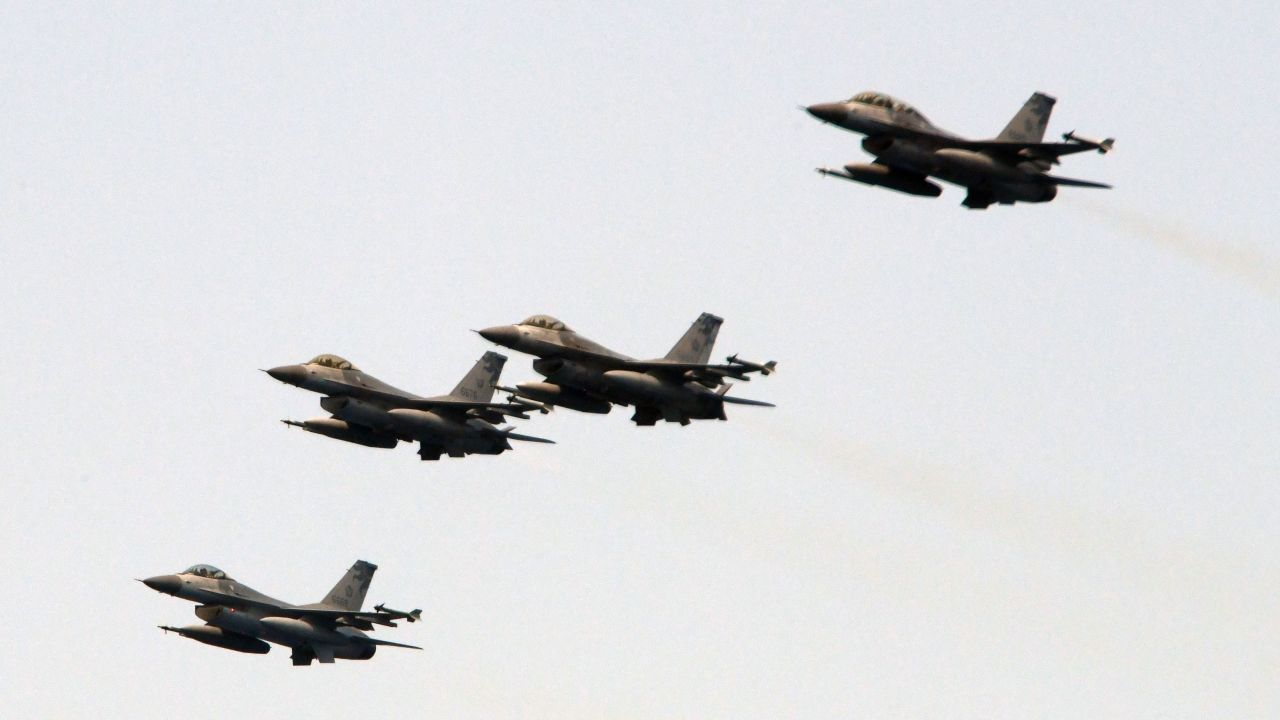 Four US-made F-16 fighter jets cross the sky during a drill near the Suao navy harbour in Yilan, eastern Taiwan, on April 13, 2018.