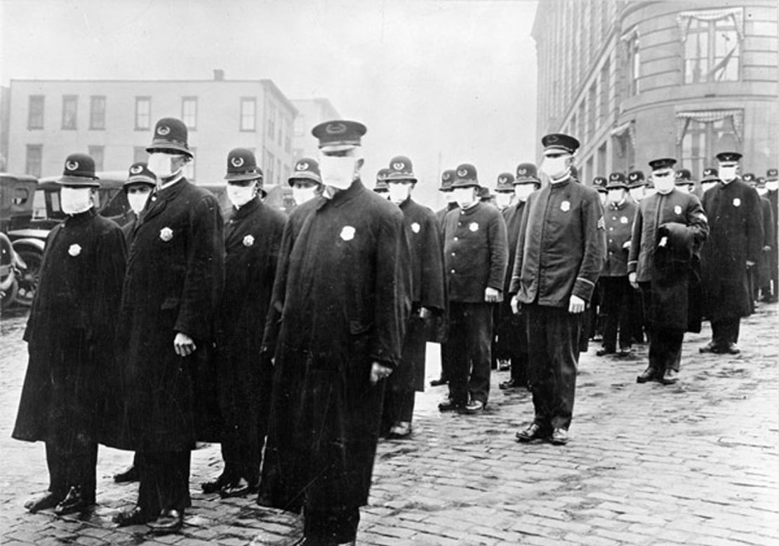 Police officers in Seattle wearing masks made by the Red Cross during the influenza epidemic in December 1918.