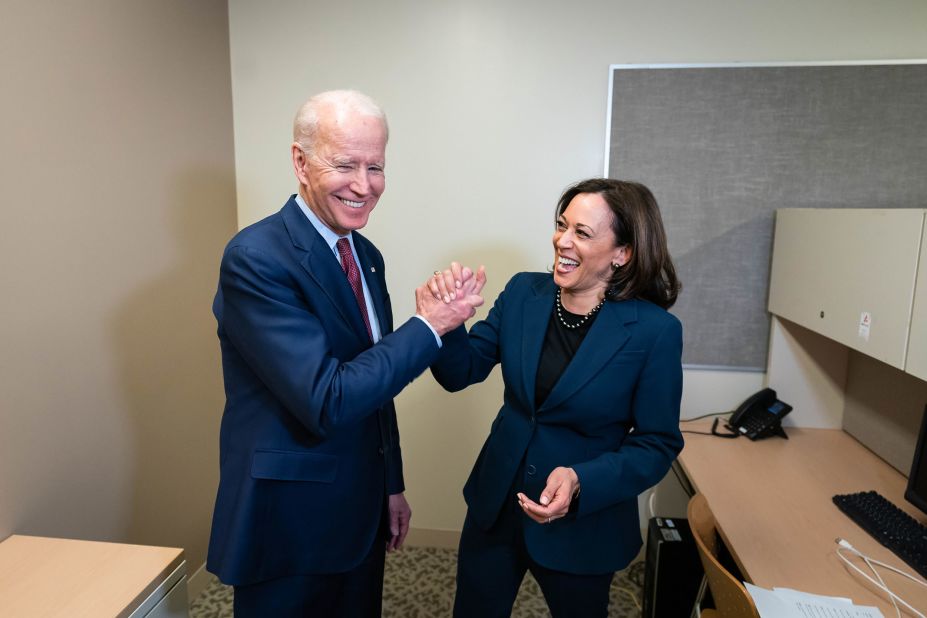 Biden and US Sen. Kamala Harris greet each other at a Detroit high school as they attend a "Get Out the Vote" event in March 2020. Harris had dropped out of the presidential race a few months earlier.