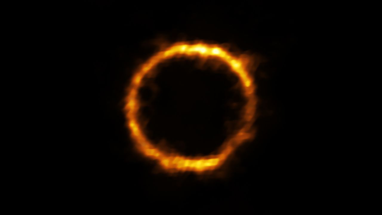 This extremely distant galaxy, which looks similar to our own Milky Way, appears like a ring of light.
