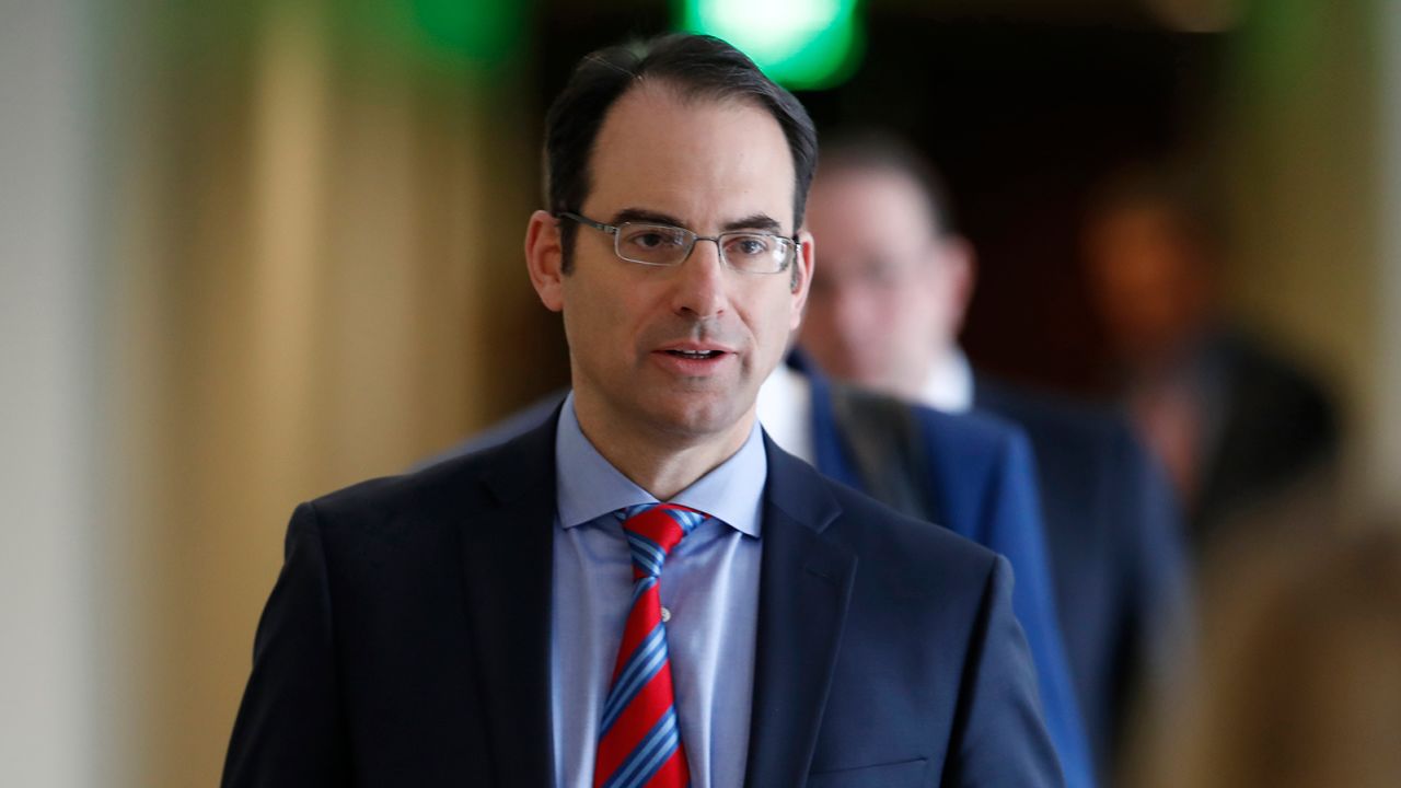 FILE--In this Tuesday, Feb. 19, 2019, file photograph, Colorado Attorney General Phil Weiser heads into a news conference to speak about the plan to have a former federal prosecutor review the sexual abuse files of Colorado's Roman Catholic dioceses in Denver. A report released on Wednesday, Oct. 23, 2019, shows that at least 166 children have been sexually abused by Catholic priests in Colorado since 1950. (AP Photo/David Zalubowski, File)
