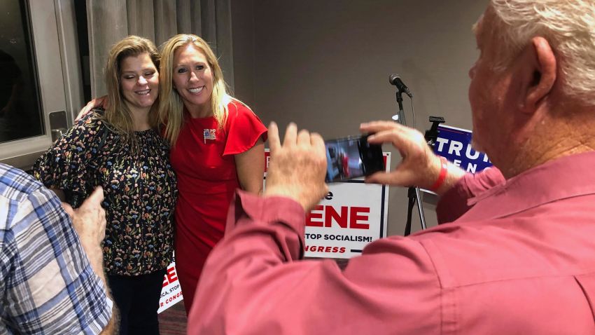 Supporters take photos with construction executive Marjorie Taylor Greene, background right, late Tuesday, August 11, 2020, in Rome, Georgia.