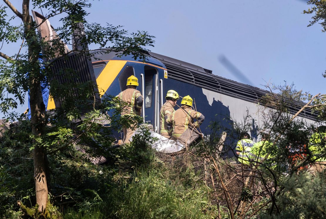 Emergency services respond to a derailed train Wednesday in Scotland.