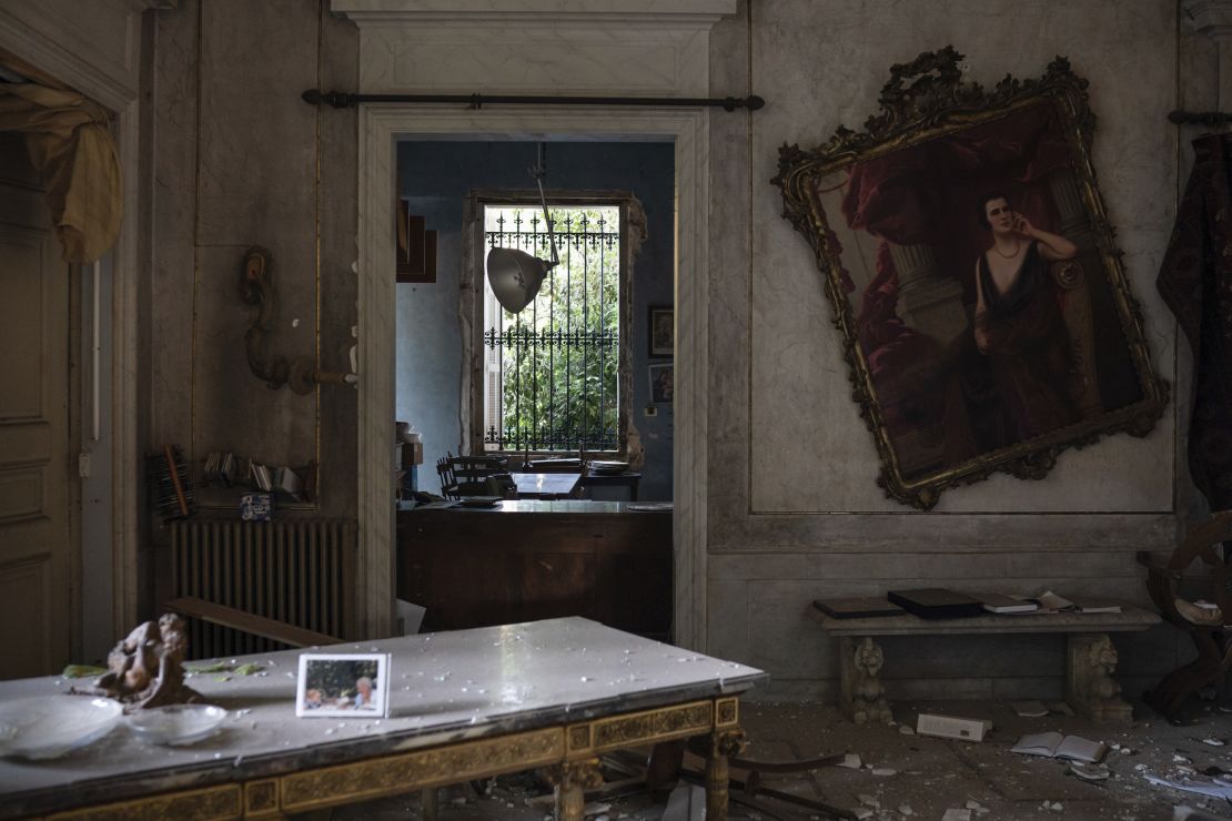 A crooked painting hangs on the wall of the Sursock Palace, heavily damaged after the explosion.