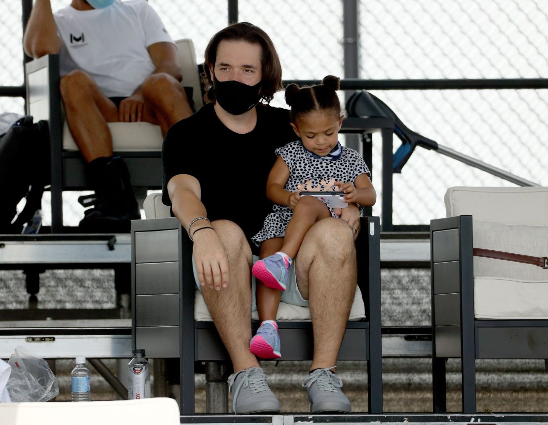 Alexis Ohanian and Olympia look on during Tuesday's match. 