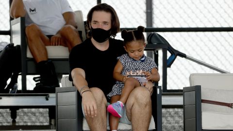 Alexis Ohanian and Olympia look on during Tuesday's match. 