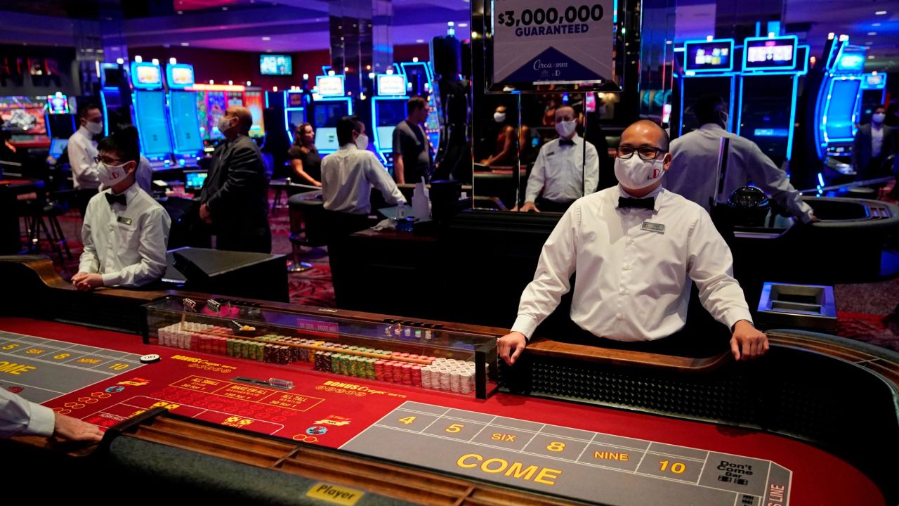 Dealers in masks await customers before the reopening of the D Las Vegas hotel and casino. 