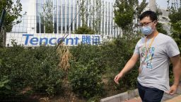 A man walks past the Tencent headquarters in Beijing, China on Friday, Aug. 7, 2020. President Donald Trump on Thursday ordered a sweeping but unspecified ban on dealings with the Chinese owners of consumer apps TikTok and WeChat, although it remains unclear if he has the legal authority to actually ban the apps from the U.S. WeChat is owned by Chinese company Tencent. (AP Photo/Ng Han Guan)