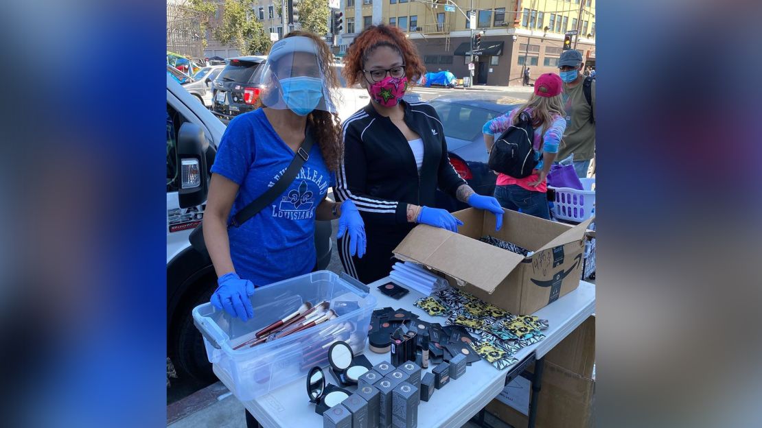 Volunteers Coco and Happiness handing out makeup to Skid Row's residents earlier this month. 