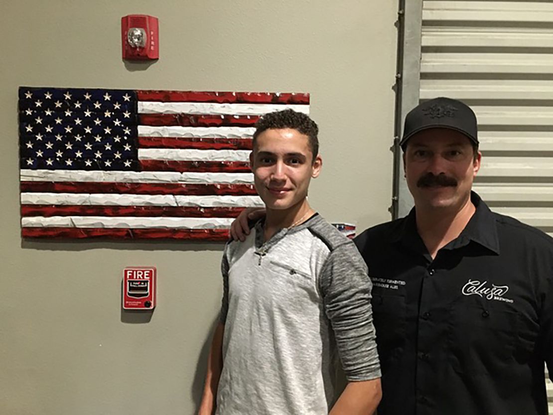 A Navy Seal Veteran who owns Calusa Brewery, son of the auction winner from the "Be The Key" Gala, with Lorenzo and his flag

