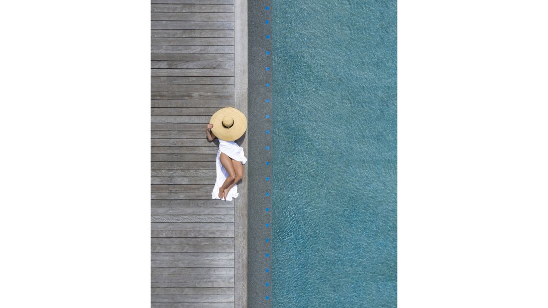 <strong>Focus point:</strong> Walls' photographs sometimes include a focus point, a figure swimming or an inflatable. Sometimes they're candid photos, other times, Walls will use a model or position props like parasols. Pictured here: a private pool in the Philippines.