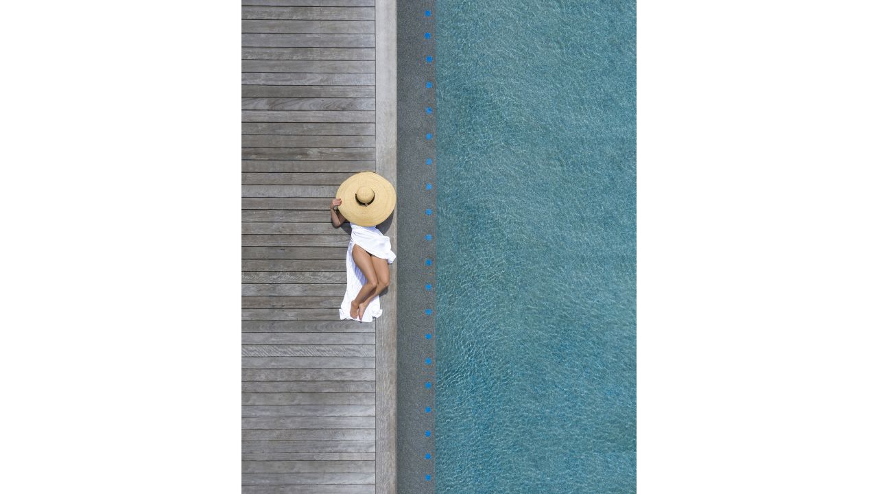 <strong>Focus point:</strong> Walls' photographs sometimes include a focus point, a figure swimming or an inflatable. Sometimes they're candid photos, other times, Walls will use a model or position props like parasols. Pictured here: a private pool in the Philippines.