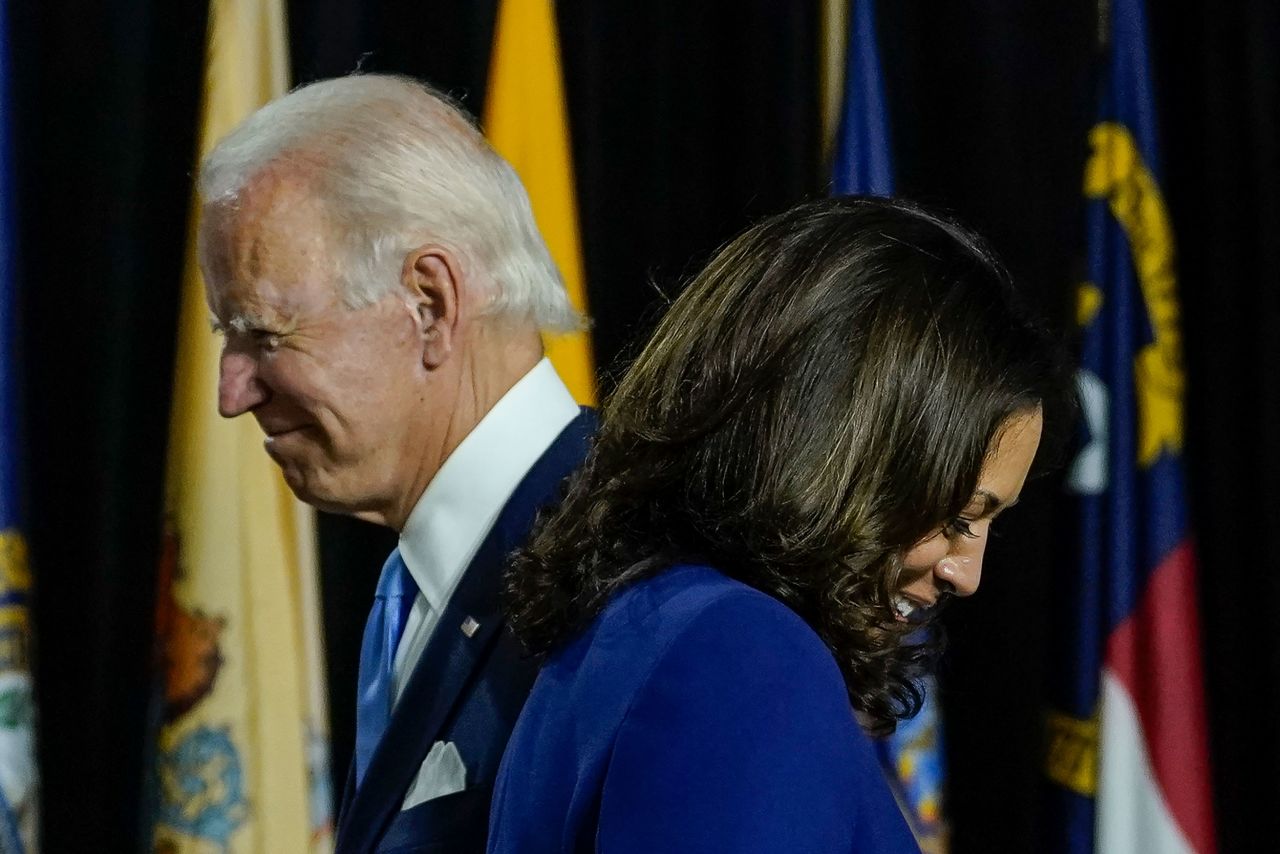 Harris passes Biden on her way to the lectern.