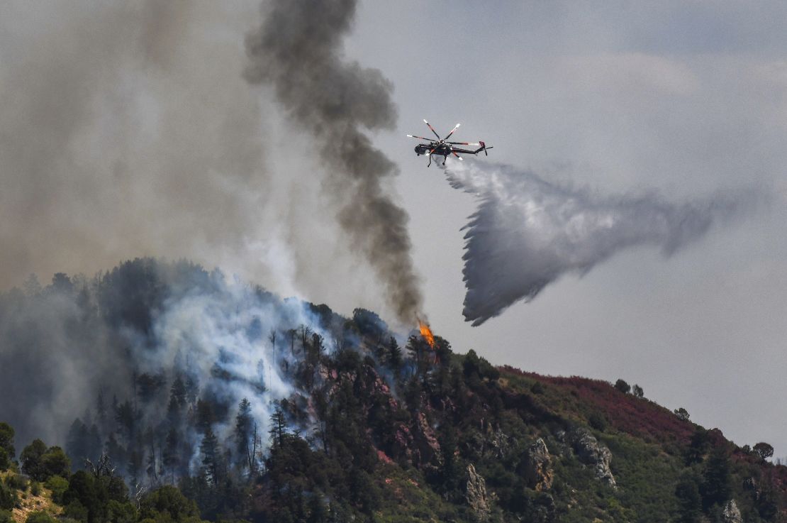 Fire crews work Tuesday to battle the Grizzly Creek Fire as it shoots down the ridge into No Name Canyon.