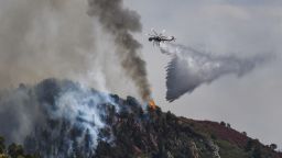 Fire crews work to battle the Grizzy Creek Fire as it shoots down the ridge into No Name Canyon in the afternoon after the fire initially started Monday on Interstate 70, near Glenwood Springs, Colo., on Tuesday, Aug. 11, 2020. (Chelsea Self/Glenwood Springs Post Independent via AP)