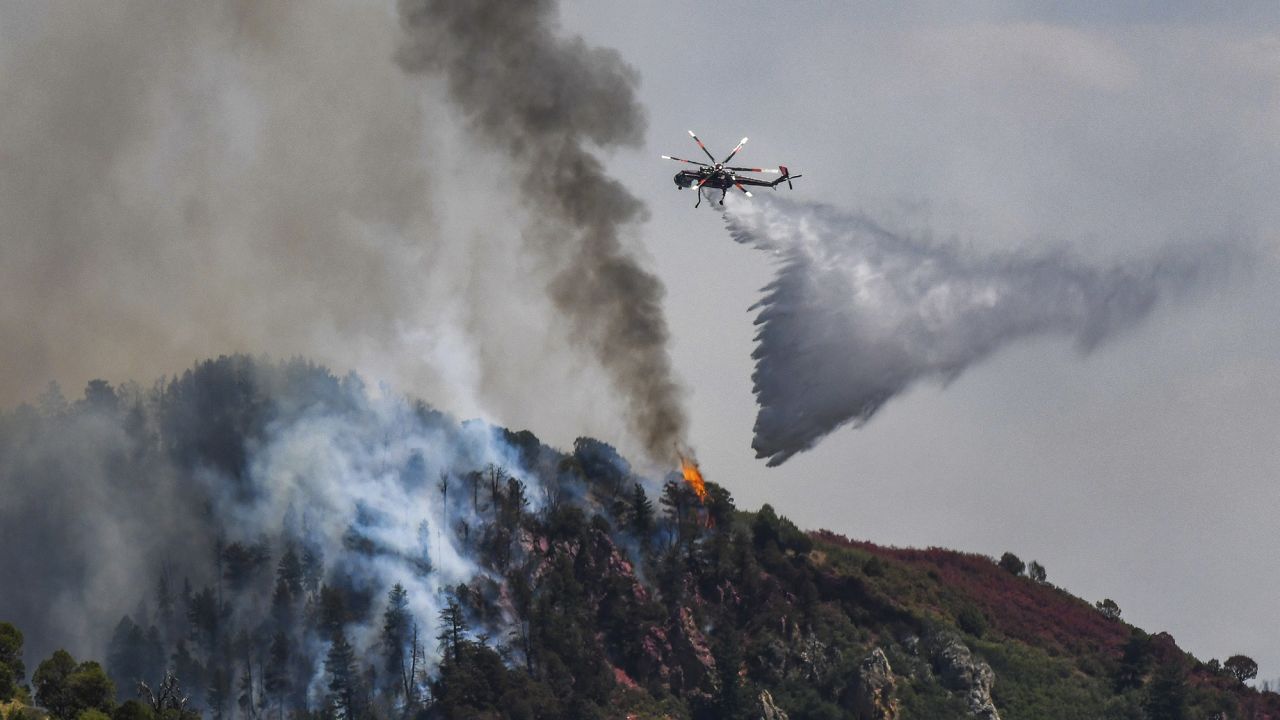 Fire crews work Tuesday to battle the Grizzly Creek Fire as it shoots down the ridge into No Name Canyon.