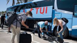 German tourists prepare to board a bus of German tour operator TUI upon their arrival at Son San Joan Aeroport  in Palma de Mallorca on June 15, 2020, as part of a pilot program to reactivate tourism a week before Spain reopens its borders. - Spain, one of the world's leading tourist destinations, will next June 21 re-establish free travel with fellow EU countries. 