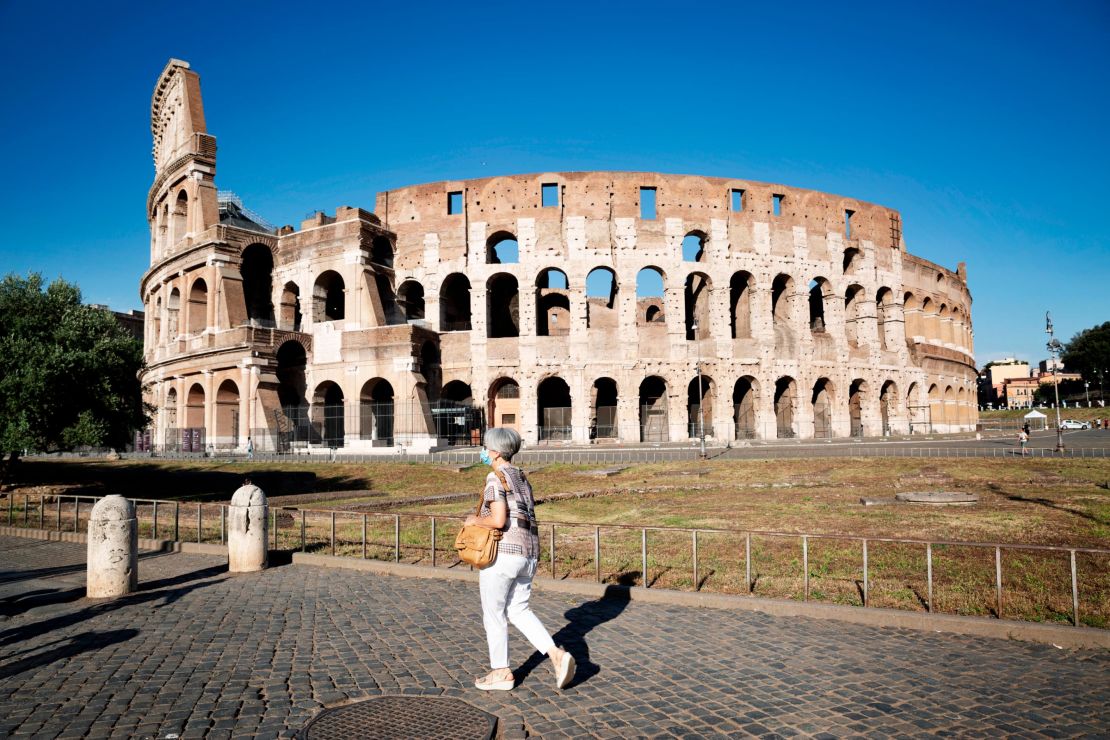 A woman walks in front of the Colosseum on July 10 in Rome, Italy. 