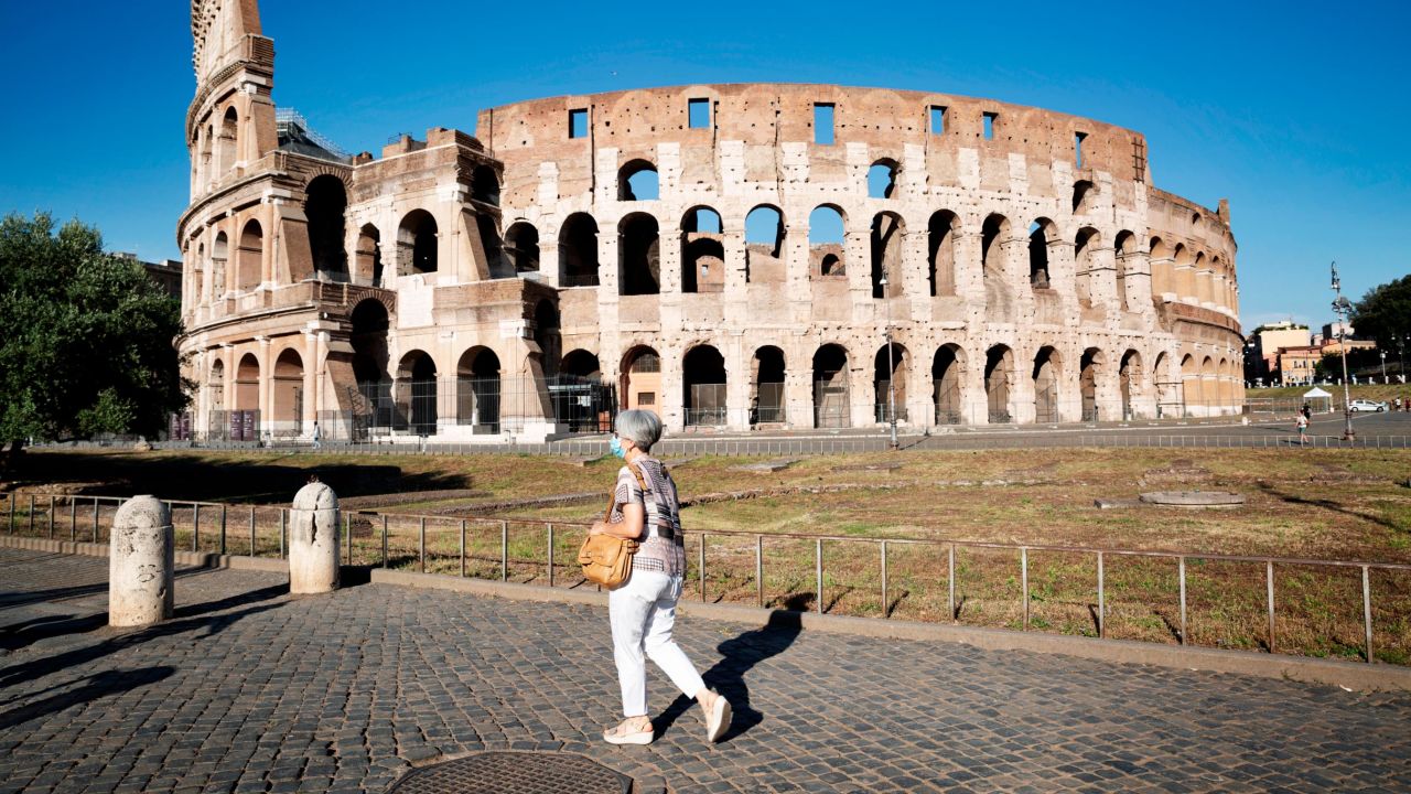 A woman walks in front of the Colosseum on July 10 in Rome, Italy.