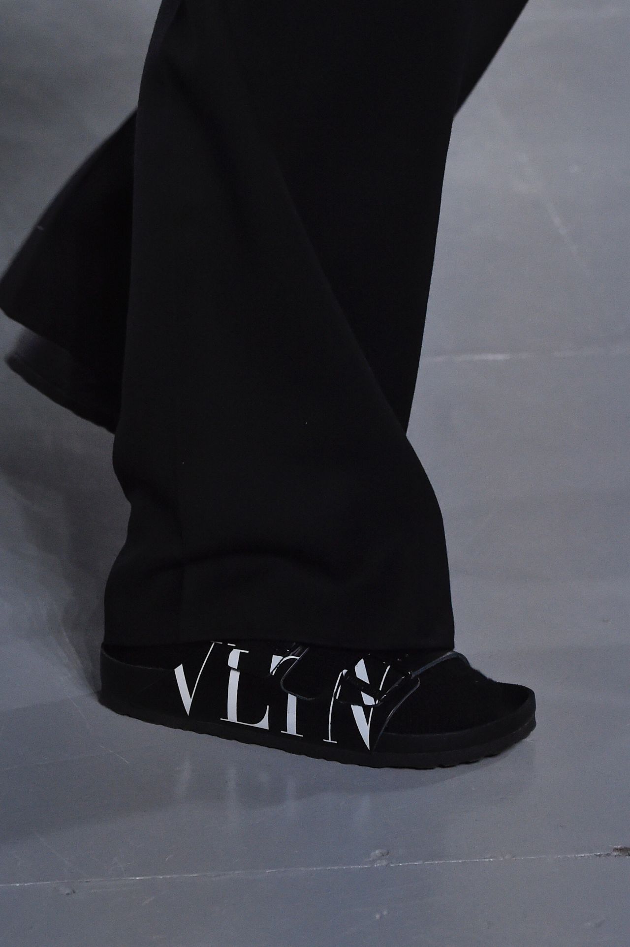A model wears a Valentino x Birkenstock shoe for Menswear Fall-Winter 2019-2020.