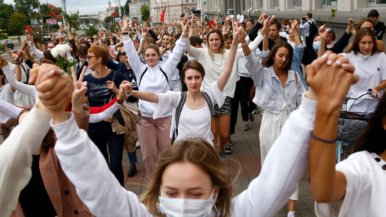 Women wearing white march in Minsk, Belarus on Wednesday, in protest against police violence during recent rallies against the results of the country's presidential election.