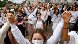 About 200 women march in solidarity with protesters injured in the latest rallies against the results of the country's presidential election in Minsk, Belarus, Wednesday, Aug. 12, 2020. Belarus officials say police detained over 1,000 people during the latest protests against the results of the country's presidential election.