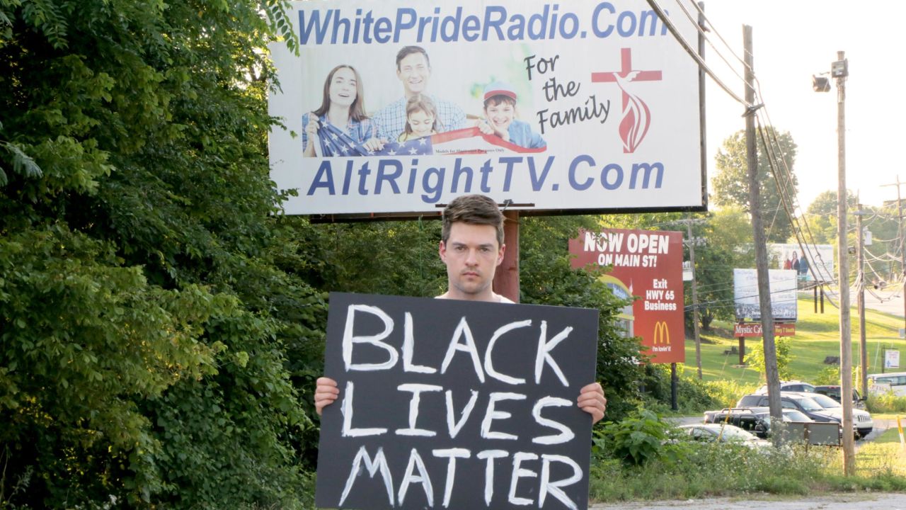 Flimmaker Rob Bliss stands in front of the controversial billboard in Harrison, Arkansas.