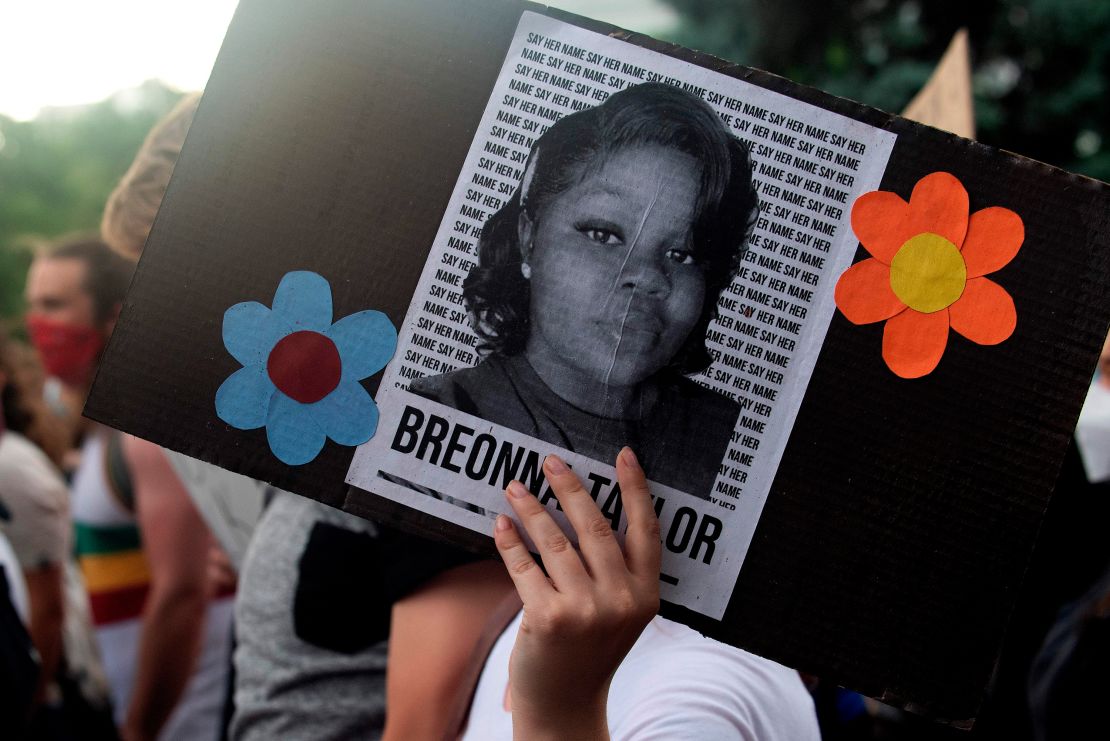 A demonstrator holds an image of Breonna Taylor during a protest in Denver last June.  
