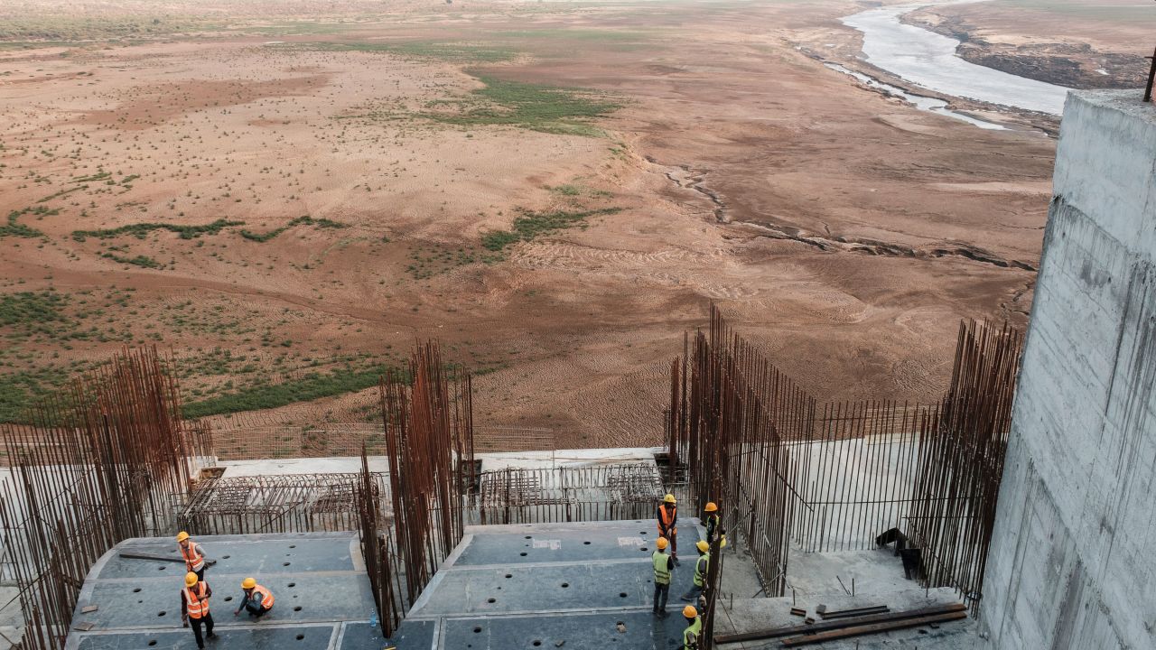 A general view of the construction works at the Grand Ethiopian Renaissance Dam (GERD),  near Guba in Ethiopia, on December 26, 2019. - The Grand Ethiopian Renaissance Dam, a 145-metre-high, 1.8-kilometre-long concrete colossus is set to become the largest hydropower plant in Africa.
Across Ethiopia, poor farmers and rich businessmen alike eagerly await the more than 6,000 megawatts of electricity officials say it will ultimately provide. 
Yet as thousands of workers toil day and night to finish the project, Ethiopian negotiators remain locked in talks over how the dam will affect downstream neighbours, principally Egypt. (Photo by EDUARDO SOTERAS / AFP) (Photo by EDUARDO SOTERAS/AFP via Getty Images)