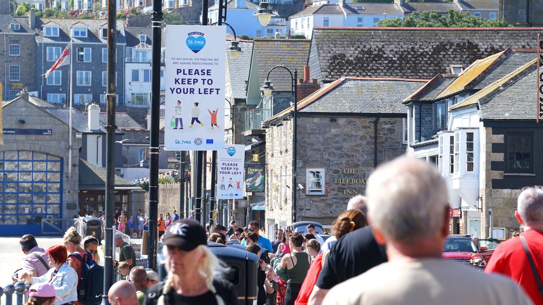 People throng the streets of St Ives, a seaside tourist town in the UK region of Cornwall.