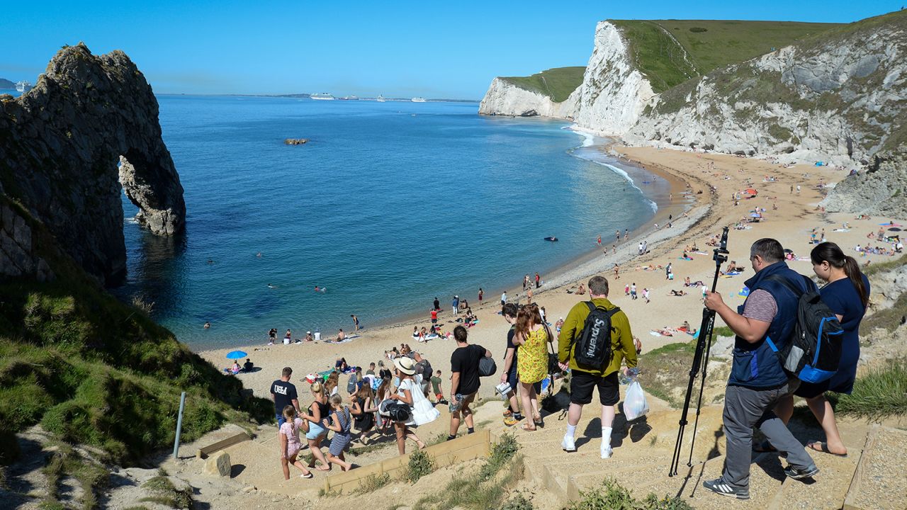 Crowds descend to Durdle Door beach in Dorset.