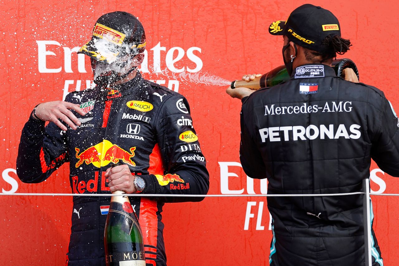 Lewis Hamilton sprays champagne on fellow Formula One driver Max Verstappen after <a href="https://www.cnn.com/2020/08/09/motorsport/anniversary-gp-verstappen-hamilton-bottas-spt-intl/index.html" target="_blank">Verstappen won the 70th Anniversary Grand Prix</a> on Sunday, August 9. Hamilton finished second in the race, which took place at England's Silverstone Circuit.