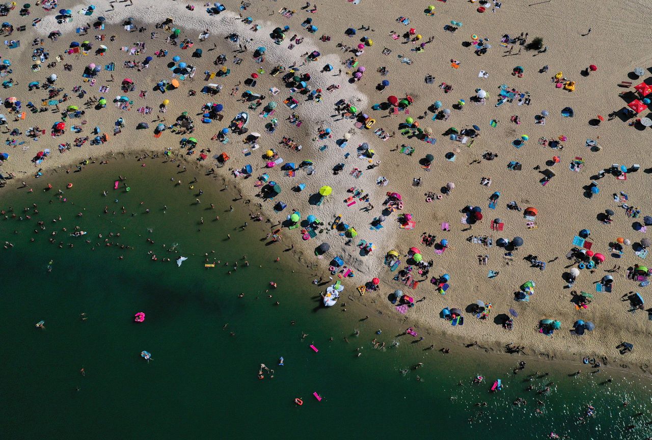 People cool off at a lake in Haltern am See, Germany, on Friday, August 7.