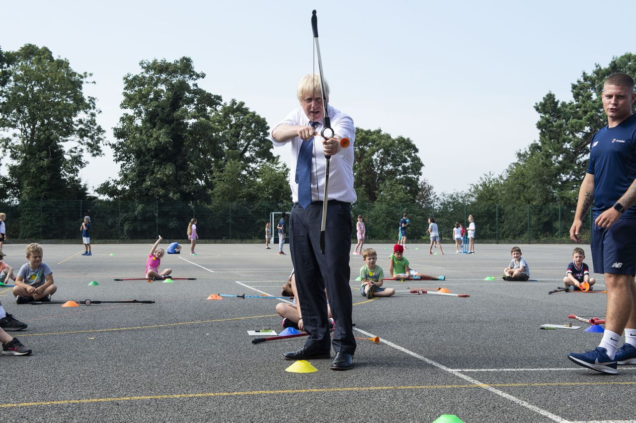 British Prime Minister Boris Johnson takes part in an archery session as he visits a summer camp in London on Monday, August 10.