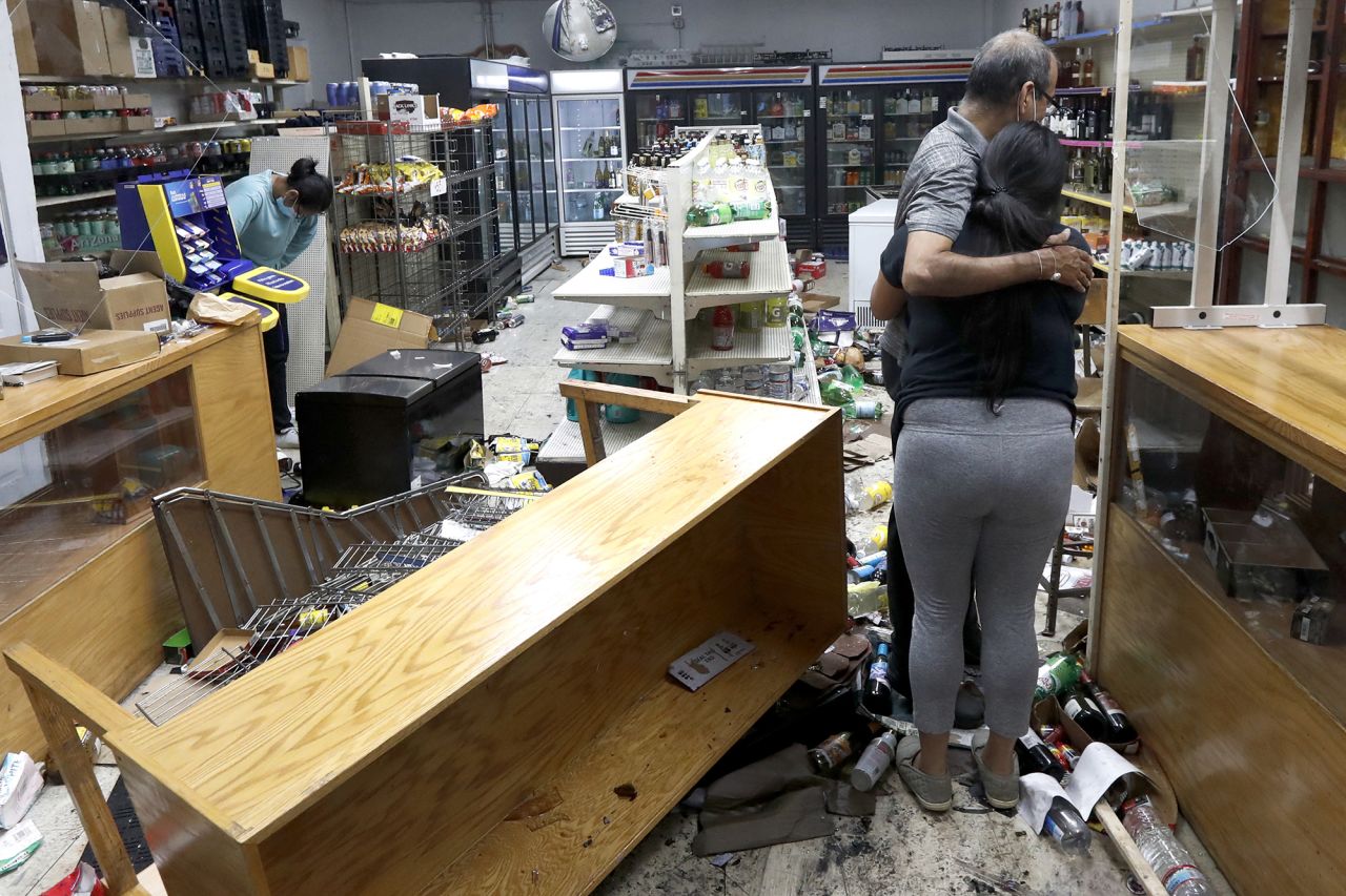 Yogi Dalal hugs his daughter, Jigisha, after the family's store was vandalized in Chicago on Monday, August 10. <a href="https://www.cnn.com/2020/08/10/us/chicago-crowds-police-looting/index.html" target="_blank">More than 100 people were arrested in Chicago</a> after an overnight fit of violence that appears to have begun with police exchanging gunfire with a 20-year-old man, Police Superintendent David Brown said. Those arrested were charged with looting, disorderly conduct, and battery against police, Brown said.